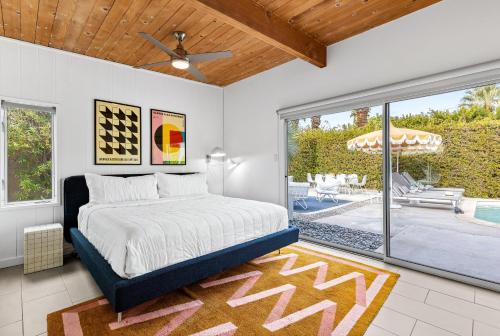 a bedroom with a bed and a patio at Mid Century Mood House in Palm Springs