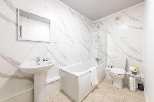 a white bathroom with a sink and a toilet at Contractors, Families, FREE PARKING, Central - Print Place by Prescott Apartments in Bristol