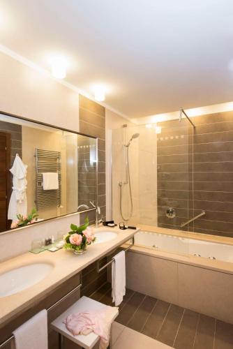 a bathroom with a tub and a sink and a shower at Best Western Premier BHR Treviso Hotel in Quinto di Treviso