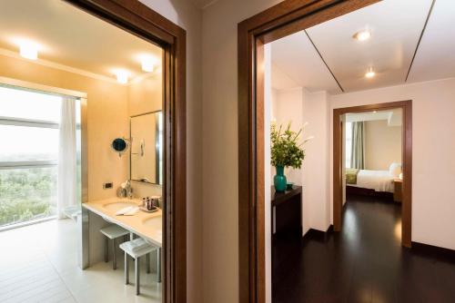 a bathroom with a sink and a mirror at Best Western Premier BHR Treviso Hotel in Quinto di Treviso