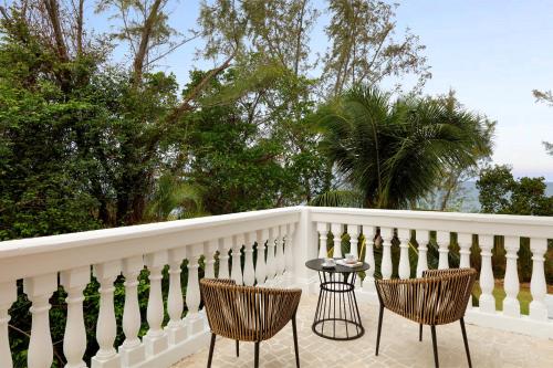 two chairs and a table on a white fence at Grand Palladium Jamaica Resort & Spa All Inclusive in Lucea