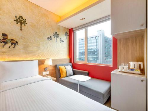 ムンバイにあるibis Mumbai Vikhroli - An Accor Brandのベッドルーム1室(ベッド1台、ソファ、窓付)