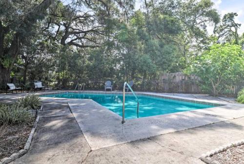 a swimming pool in a yard with trees at Pool home sleeps 6 with large fenced yard in Jacksonville