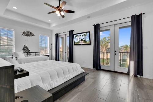 a bedroom with a bed and a ceiling fan at Paradise Villa: 2 blocks from beach, private pool in South Padre Island