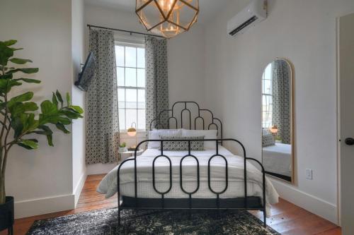 a bedroom with a bed and a mirror at Sugar's INN Room #2 in Galveston