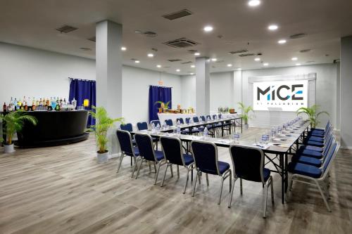a conference room with a long table and blue chairs at Grand Palladium Jamaica Resort & Spa All Inclusive in Lucea