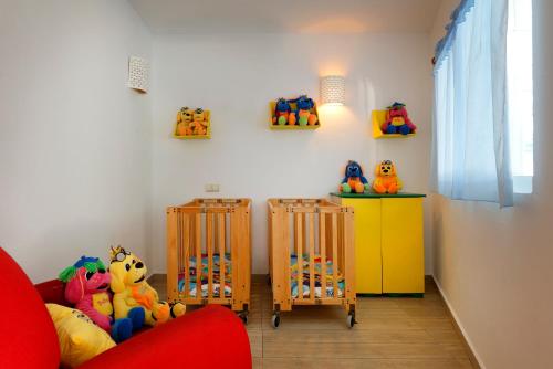 a room with two cribs and toys on the wall at Grand Palladium Jamaica Resort & Spa All Inclusive in Lucea