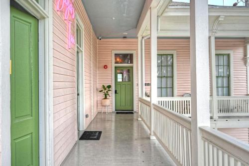 a front door of a pink house with a green door at Sugar's INN Room #1 in Galveston