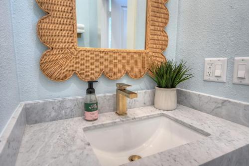 a bathroom sink with a mirror on a counter at Sugar's INN Room #1 in Galveston