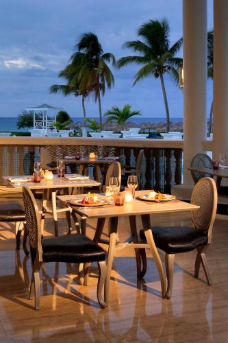 a restaurant with tables and chairs with a view of the ocean at Grand Palladium Jamaica Resort & Spa All Inclusive in Lucea