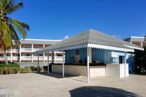 a small blue building with a roof in front of a building at Grand Palladium Jamaica Resort & Spa All Inclusive in Lucea