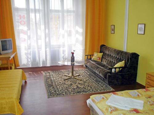 a living room with a couch and a table at Hotel Morava in Znojmo