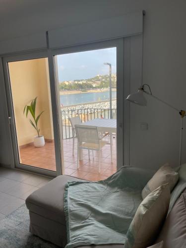 a living room with a couch and a view of the ocean at Aquamarine Sant Feliu en la playa con patio in Sant Feliu de Guixols