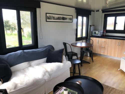 a living room with a couch and a table at Adorable little container house in Hastings