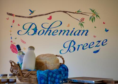 a sign on a wall with a basket of bread at Bohemian Breeze in Bald Knob