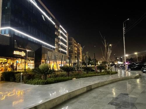 a city street at night with a building at Cairo Heliopolis Apartment in Cairo