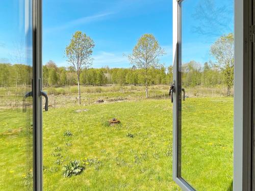 a view of a field from a window at 6 person holiday home in TINGSRYD-By Traum in Tingsryd