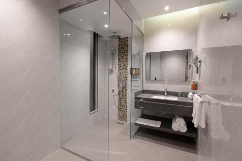 a bathroom with a glass shower and a sink at Holiday Inn Riyadh The Business District, an IHG Hotel in Riyadh