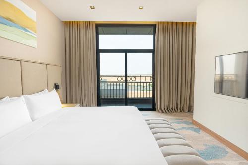 a hotel room with a bed and a large window at Holiday Inn Riyadh The Business District by IHG in Riyadh
