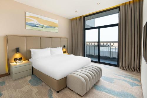 a bedroom with a large bed and a large window at Holiday Inn Riyadh The Business District by IHG in Riyadh
