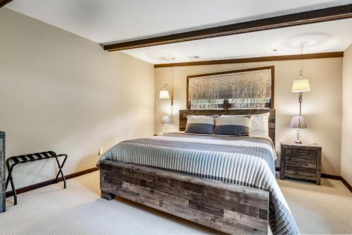 a bedroom with a large bed with a wooden headboard at Unforgettable Lake Memories in Lake Ozark