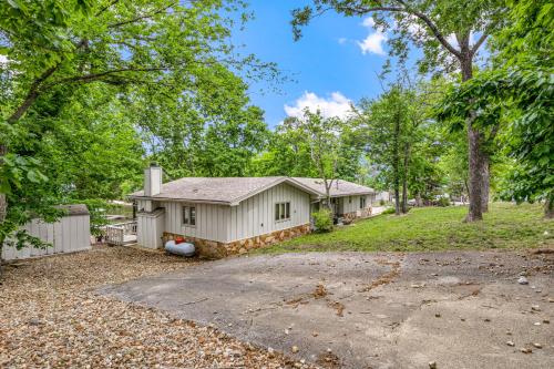 a home in the woods with a driveway at Unforgettable Lake Memories in Lake Ozark