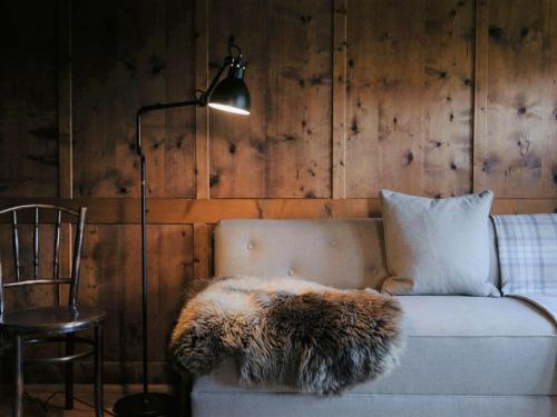 a couch with a furry pillow and a lamp at Chalet in Montafon with Private Sauna & Views in Vandans