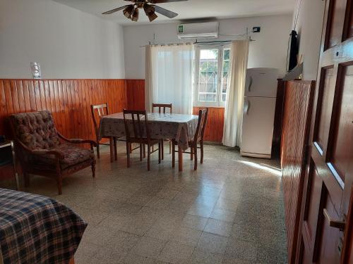 a kitchen with a table and chairs and a refrigerator at DEPARTAMENTO CON COCHERA in La Rioja