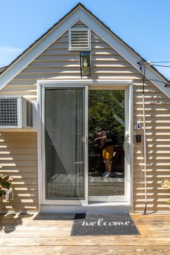 a house with a sliding glass door on a deck at Elegance at Huntington Spacious Family Apt Yard in Huntington Station