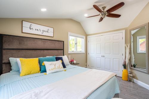 a bedroom with a bed and a ceiling fan at Elegance at Huntington Spacious Family Apt Yard in Huntington Station