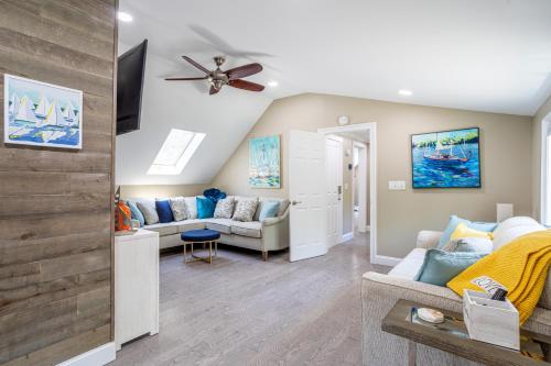 a living room with a couch and a ceiling fan at Elegance at Huntington Spacious Family Apt Yard in Huntington Station