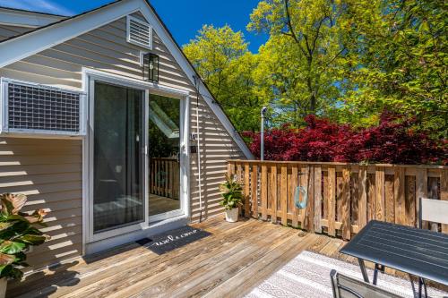 a house with a deck with a sliding glass door at Elegance at Huntington Spacious Family Apt Yard in Huntington Station