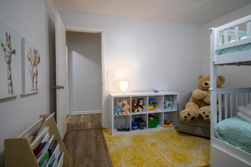 a bedroom with a bunk bed and a teddy bear at Home Away in Taylors by Brick and Home in Taylors