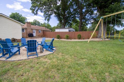 a group of blue chairs sitting in a yard at Home Away in Taylors by Brick and Home in Taylors