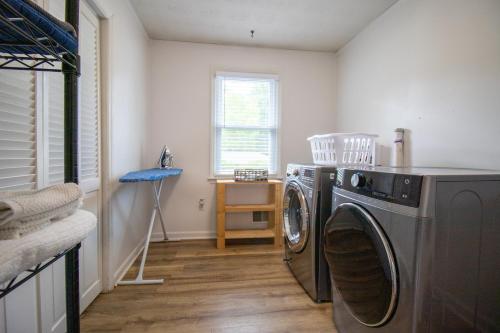 a laundry room with a washing machine in it at Home Away in Taylors by Brick and Home in Taylors