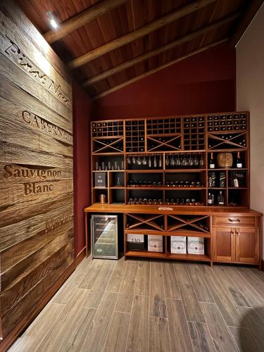 a wine tasting room with wooden walls and a wine cellar at Lavandas de Cunha Pousada Boutique in Cunha