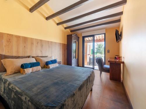 a bedroom with a large bed and a desk at Villa Jen'uka with private pool in Callian