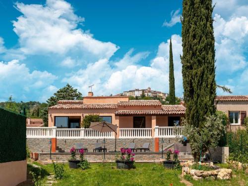 a house with a white fence and a tree at Villa Jen'uka with private pool in Callian