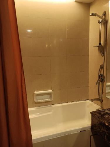 a bathroom with a bath tub with a shower at Vacation Stay at Resort Suites Bandar Sunway in Kampong Penaga