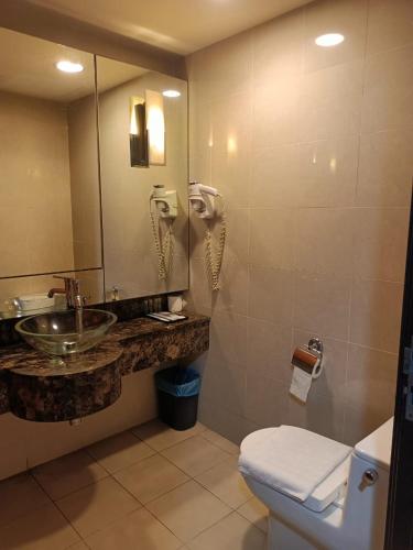 a bathroom with a sink and a toilet and a phone at Vacation Stay at Resort Suites Bandar Sunway in Kampong Penaga