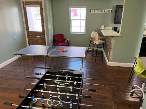 a ping pong table in a living room with a ping pong table at Chillpad Blocks from FrenchQuarters in New Orleans