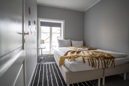 a bedroom with a bed and a window at In Heart of Stavanger BnB with Billiard & Sauna in Stavanger