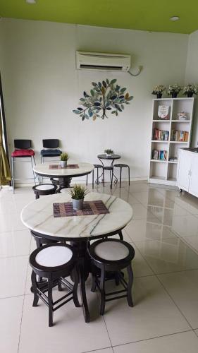 a group of tables and stools in a room at Olive Hotel in Johor Bahru