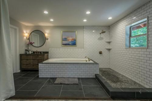 a bathroom with a tub and a sink and a mirror at Modern Open Concept Mountain View NEW Home in Mount Shasta