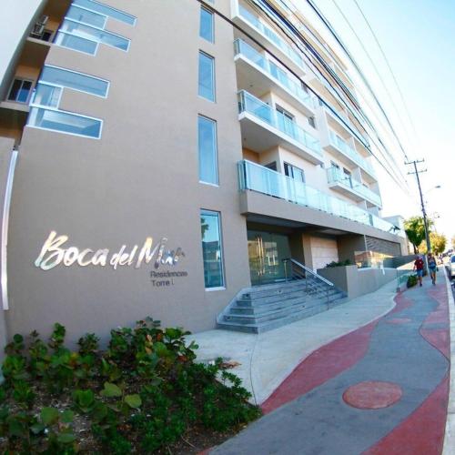 a building with a sign on the side of it at Simply the most comfortable place next to Boca Chica beach in Boca Chica