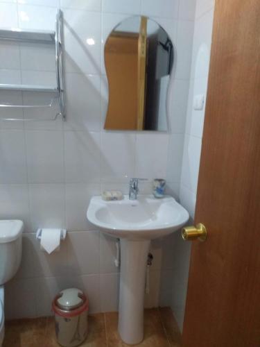 a bathroom with a sink and a toilet and a mirror at hostal casa talitha in San Pedro de Atacama