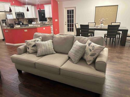 a couch with pillows sitting in a living room at Florida Oasis in Auburndale