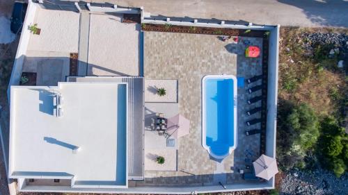an overhead view of a building with a pool at Villa Blazen in Bogomolje