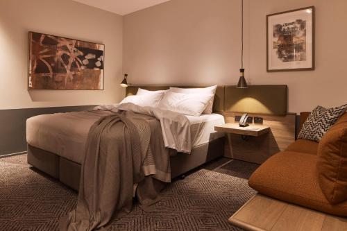 a hotel room with a bed and a couch at Rydges Melbourne in Melbourne