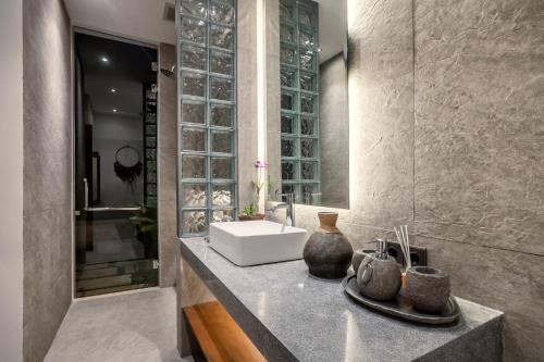 a bathroom with a sink and a counter with a sink at Villa Jehanne by BaliSuperHost in Ubud